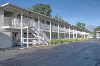 a large white building with stairs on the side of it at Motel 6-Bishop, CA in Bishop