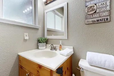 a bathroom with a sink and a mirror at Welcoming Tahoe-Donner Cabin in Truckee
