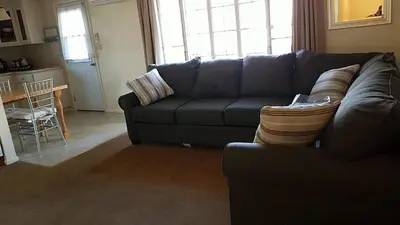 a living room with a blue couch and a kitchen at Becky's Condo in Mariposa