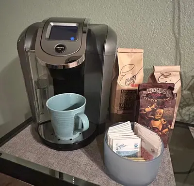 a coffee maker and a cup on a glass table at Kin House Guest Suite in Oakhurst
