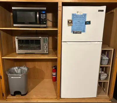 a refrigerator in a kitchen with a microwave at Kin House Guest Suite in Oakhurst