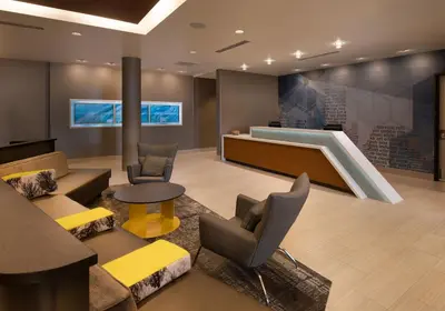 a lobby with a waiting area with chairs and a table at SpringHill Suites by Marriott Reno in Reno
