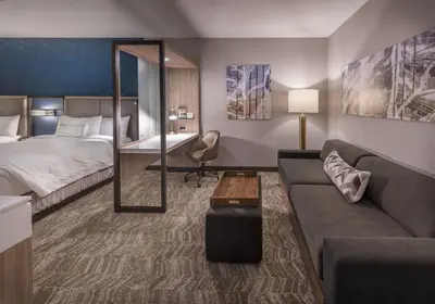 a hotel room with a bed and a couch at SpringHill Suites by Marriott Reno in Reno