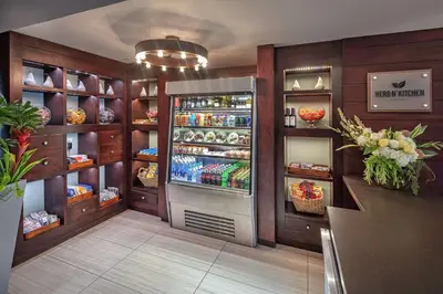 a kitchen with an open refrigerator in a restaurant at Hilton Sacramento Arden West in Sacramento