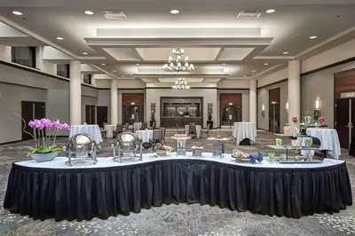 a banquet hall with a large table in the middle at Hilton Sacramento Arden West in Sacramento