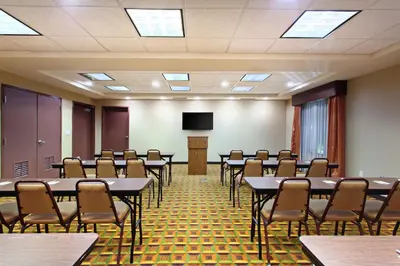 a conference room with tables and chairs and a podium at Hampton Inn & Suites Fresno - Northwest in Herndon