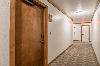a hallway with a door and a tile floor at Mountainback 80 in Mammoth Lakes