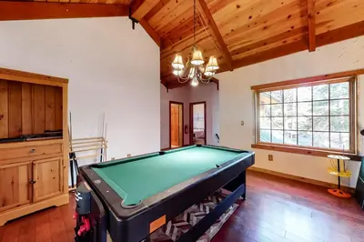 a pool table in the middle of a room at The Acorn House in Truckee