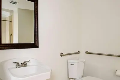 a bathroom with a sink and a toilet and a mirror at Motel 6-Modesto, CA - Downtown in Modesto