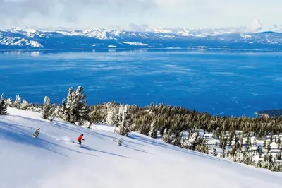 a person is skiing down a snow covered slope at Luxury 2Br Residence Steps From Heavenly Village & Gondola Condo in South Lake Tahoe