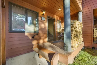 a wooden bench on the side of a house at Mammoth Village Properties by 101 Great Escapes in Mammoth Lakes