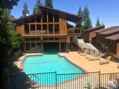 a house with a swimming pool in front of a house at Timber Ridge Resort by 101 Great Escapes in Mammoth Lakes