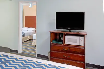 a room with a flat screen tv on a dresser at Travelodge by Wyndham Bishop in Bishop