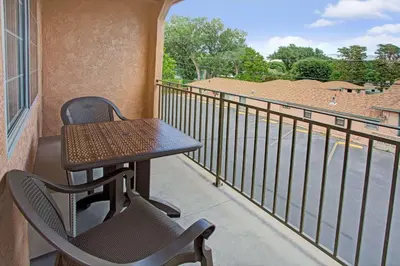 a table and chairs on a balcony with a view at Travelodge by Wyndham Bishop in Bishop