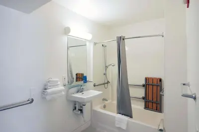 a white bathroom with a sink and a shower at Motel 6-Mammoth Lakes, CA in Mammoth Lakes