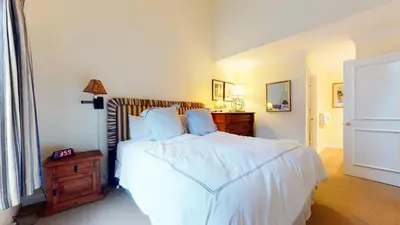 a bedroom with a white bed with a wooden headboard at Snowcreek Iii #420 Condo in Mammoth Lakes