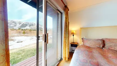 a bedroom with a bed and a large window at Snowcreek Iii #420 Condo in Mammoth Lakes