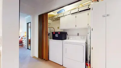 a kitchen with white cabinets and a washer and dryer at Snowcreek Iii #420 Condo in Mammoth Lakes