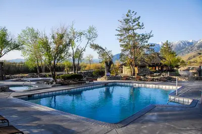 a swimming pool in a resort with mountains in the background at Holiday Inn Club Vacations - David Walley's Resort in Genoa