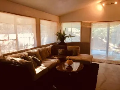 a living room with a couch and a table at A Lovely Cabin House at Way Woods Retreat with Outdoor Hot Tub! - By Sacred Hub MGMT in Foresthill