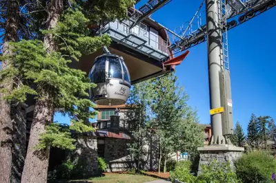 a bucket hanging from a crane in front of a building at Chateau Blanc 23 in Mammoth Lakes