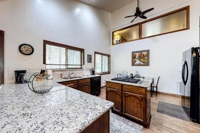 a large kitchen with a sink and a refrigerator at Cherry Retreat in South Lake Tahoe