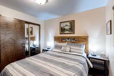 a bedroom with a large bed and two night stands at Cherry Retreat in South Lake Tahoe