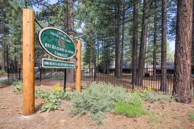 a sign in front of a fence with a park at Cherry Retreat in South Lake Tahoe