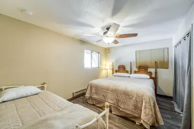a bedroom with two beds and a ceiling fan at Tamarack Dream in Lakeshore