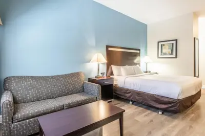 a hotel room with a bed and a couch at Quality Inn near Mammoth Mountain Ski Resort in Mammoth Lakes