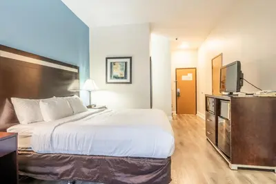 a hotel room with a bed and a flat screen tv at Quality Inn near Mammoth Mountain Ski Resort in Mammoth Lakes