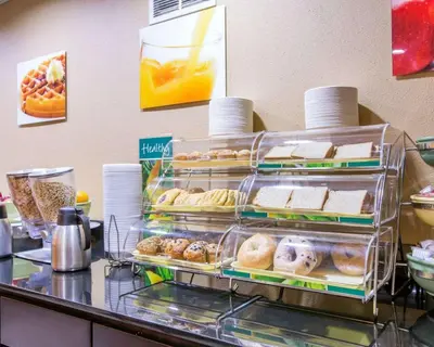 a buffet line with a bunch of pastries and donuts at Quality Inn near Mammoth Mountain Ski Resort in Mammoth Lakes
