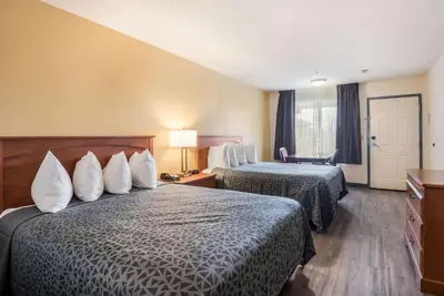 a hotel room with two beds and a window at Econo Lodge Inn & Suites Lodi - Wine Country Area in Lodi