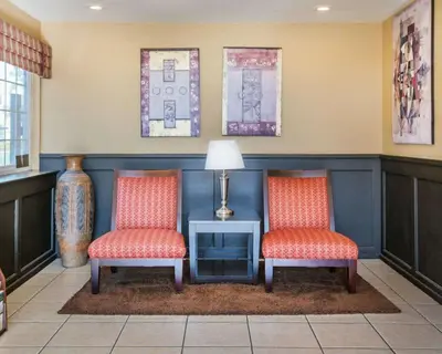two chairs in a waiting room with a tv at Econo Lodge Inn & Suites Lodi - Wine Country Area in Lodi