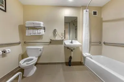 a bathroom with a toilet and a sink and a tub at Comfort Suites Visalia - Convention Center in Visalia