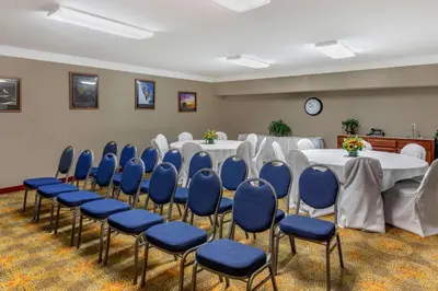 a conference room with tables and chairs and a clock at Comfort Suites Visalia - Convention Center in Visalia