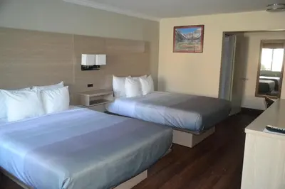 a hotel room with two beds and a television at Quality Inn Bishop near Mammoth in Bishop