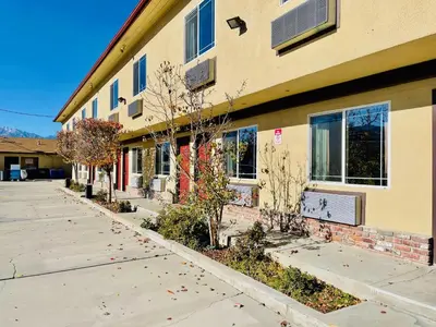 a building with a sidewalk in front of it at Quality Inn Bishop near Mammoth in Bishop
