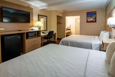 a hotel room with two beds and a flat screen tv at Quality Inn Bishop near Mammoth in Bishop