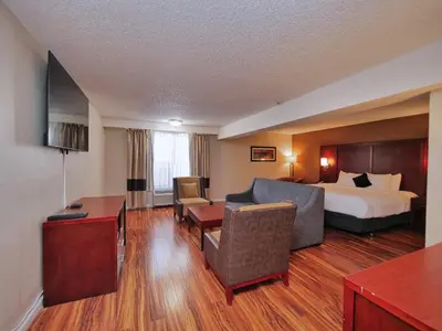 a hotel room with a bed and a desk at Red Lion Inn & Suites Auburn in Auburn
