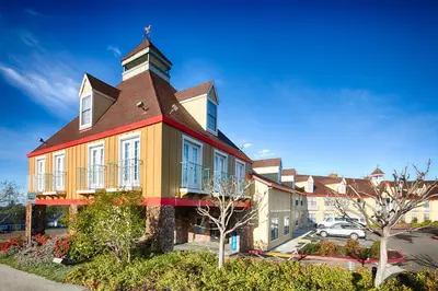 a large building with a tower on top of it at Red Lion Inn & Suites Auburn in Auburn