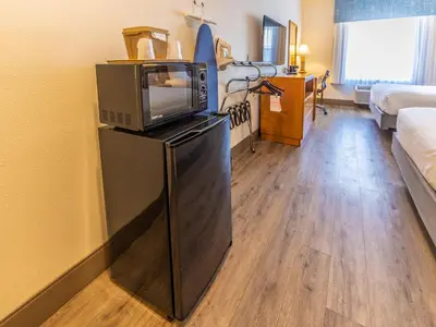 a living room with a microwave and a television at The Hanford Hotel, an Ascend Collection Hotel in Hanford