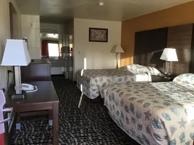 a hotel room with two beds and a desk at Executive Inn westley,CA in Westley