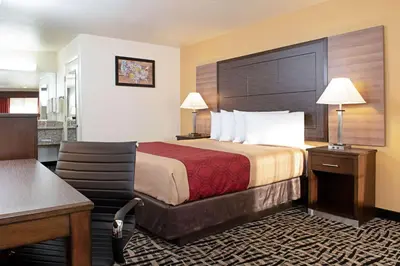 a hotel room with a bed and a desk at Executive Inn westley,CA in Westley