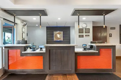 an office with a lobby with orange accents at Comfort Inn & Suites Sacramento - University Area in Sacramento
