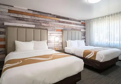 a hotel room with two beds and a window at Quality Inn South Lake Tahoe in South Lake Tahoe