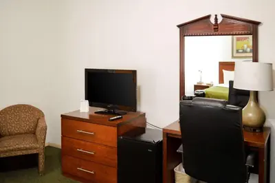 a hotel room with a television and a desk with a chair at Quality Inn Yosemite Valley Gateway in Mariposa