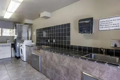 a large kitchen with a sink and a refrigerator at Comfort Inn Bishop in Bishop