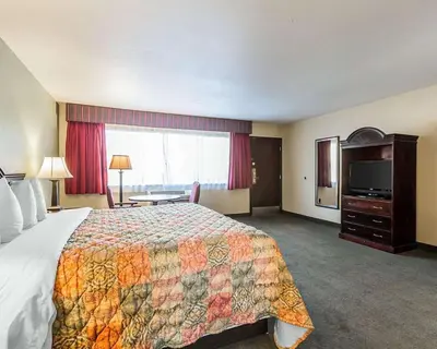 a hotel room with a bed and a television at Quality Inn & Suites Cameron Park Shingle Springs in Cameron Park