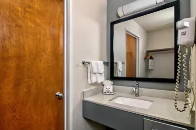 a bathroom with a sink and a mirror at Quality Inn & Suites South San Jose - Morgan Hill in Morgan Hill